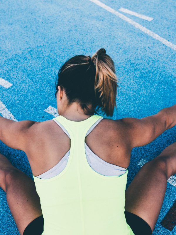 Woman stretching leg to warm up her muscles for run